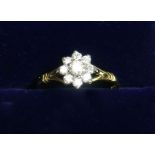 An 18 carat gold diamond cluster ring, size L 1/2