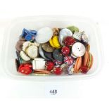 A box of various vintage buttons including four glass fish form buttons