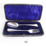 A Georgian silver christening spoon and a later fork (cased).
