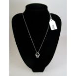 A grey pearl pendant necklace with diamond set swirl loop and 18 carat white gold chain, from Beards