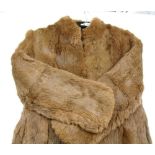 A fur coat and three stoles