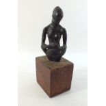 A bronze torso of a woman on a wooden base. 22cm high.