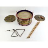 A small vintage drum, a pair of cymbals, two triangles and sticks