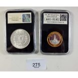 Two encased coins in presentation boxes: a USA silver Morgan dollar 1921 - 7 tailfeathers, and a