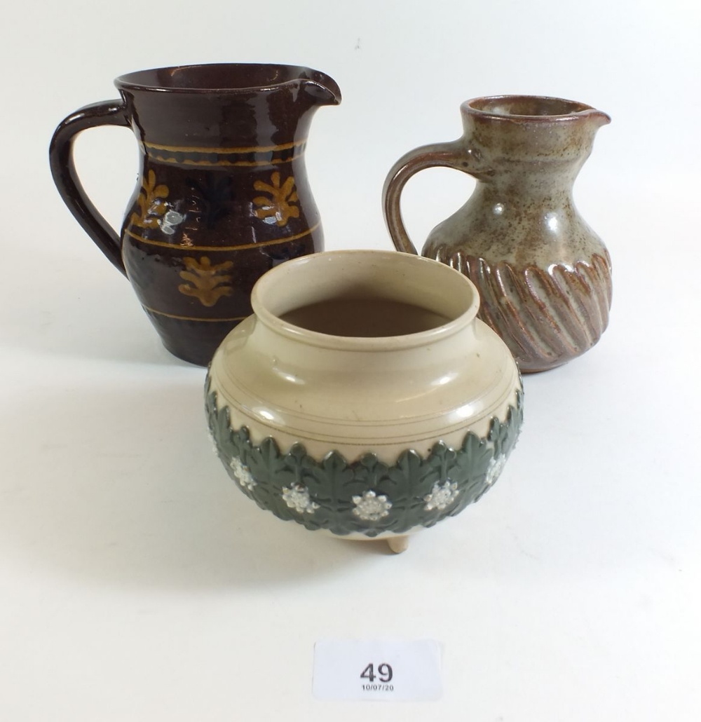 A slipware jug 15cm tall, a stoneware jug and a Royal Doulton stoneware pot