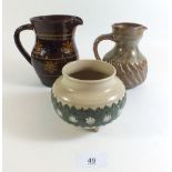 A slipware jug 15cm tall, a stoneware jug and a Royal Doulton stoneware pot