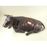 A large Japanese Meiji period bronze of a reclining bull - 42cm long - signed to base