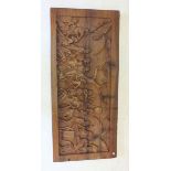 An African carved wood panel depicting figures - 44 x 99cm