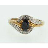 A 9ct gold sapphire and diamond set crossover ring, Size L