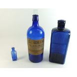 An Admiralty blue glass 24oz poison or medicine bottle with arrow mark, plus two
