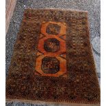 A Turkoman style rug with three large guls on an orange ground 196 x 140cm