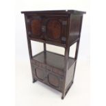 A 19th century Chinese cabinet with cupboard over recess over three small drawers and cabinet, brass