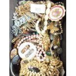 A tray of costume jewellery inc. brooches, necklaces, bracelets etc.