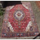 A large multi colour Persian Tabriz carpet with traditional medallion design, 295 x 200cm