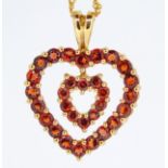 A 9ct gold heart pendant set red stones