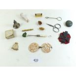 A small box of collectable trinkets including mother of pearl Navy buckle, cap badges etc