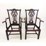 A pair of mid 20th century Chippendale style carved mahogany carver chairs with interlaced splats,