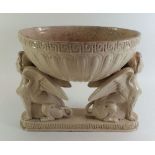 An Etruscan style potery bowl on sphinx supports, 23.5cm tal