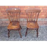 A pair of 19th Century elm seated slat back farmhouse chairs
