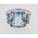 An Art Deco 18 carat white gold and platinum set aquamarine flanked by six diamonds, size L