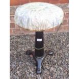 A cast iron singer sewing stool with revolving top - marked Singer to the three feet
