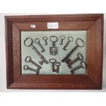 A framed display of 19th Century steel keys - 26cm x 34cm