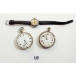 Two silver pocket watches and a Swiss white metal wrist watch - possibly a WWI trench watch