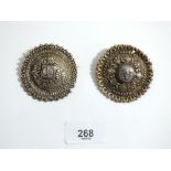 A pair of Middle Eastern white metal brooches set coins. 5.5cm diameter
