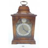 An antique style mahogany mantel clock with battery movement - 26cm
