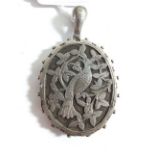 A large Victorian silver locket decorated with a bird 5cm x 4cm