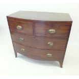 An early 19th century mahogany bow fronted chest of two short and two long drawers on splay legs
