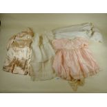 An Edwardian lace christening gown and slip together with a satin jacket and two other items of