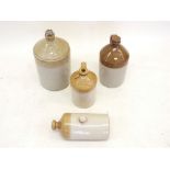 Three large stoneware jars and a stoneware hot water bottle