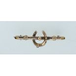 A 9 carat gold horse shoe and riding crop brooch, 3.7cm long, 1.1g