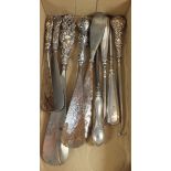 Five silver handled shoe horns and four silver handled button hooks