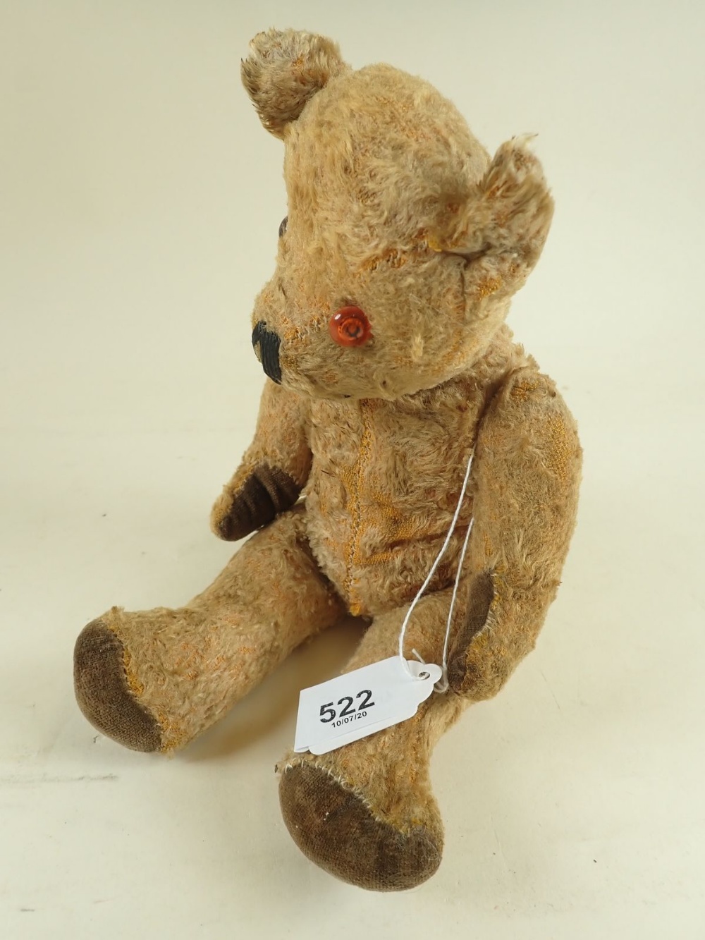 An early 20th century gold plush jointed teddy bear with glass eyes, velvet paws and stitched - Image 2 of 2