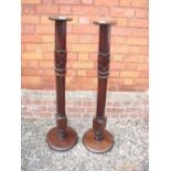 A pair of mahogany torchere stands with carved decoration - 121cm tall