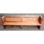 A 19th century pitch pine pew carved to one end - from Dymock Church - 230cm