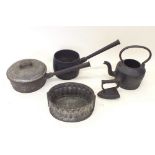 A group of Victorian kitchen items including iron, saucepans, moulds etc