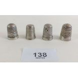 Four silver thimbles