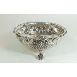 A silver bowl embossed flowers with three mask and scroll supports, London 1875, 147g, by Robert