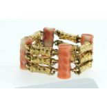 A 1960's coral and textured 14 carat gold triple flexible link ring, total weight 10g, size m