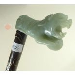 A Chinese carved jade lion walking stick handle on later stick