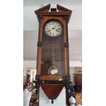 A 19th century small wall clock with walnut and ebonized case 7cm