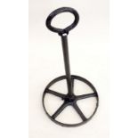 A wrought iron circular boot scraper made from an old wheel