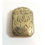 A rectangular yellow metal engraved pendant locket marked GF