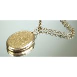 A 15 carat gold front and back oval engraved locket and a gold plated fob chain