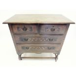 An early 20th century oak chest of drawers in 17th century style with carved decoration