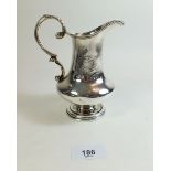 A silver cream jug with engraved amorial and Latin inscription, London 1829 by JCE, 236, 15cm