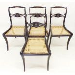 A set of four early 20th century Regency style dining chairs with cane seats and gilt metal
